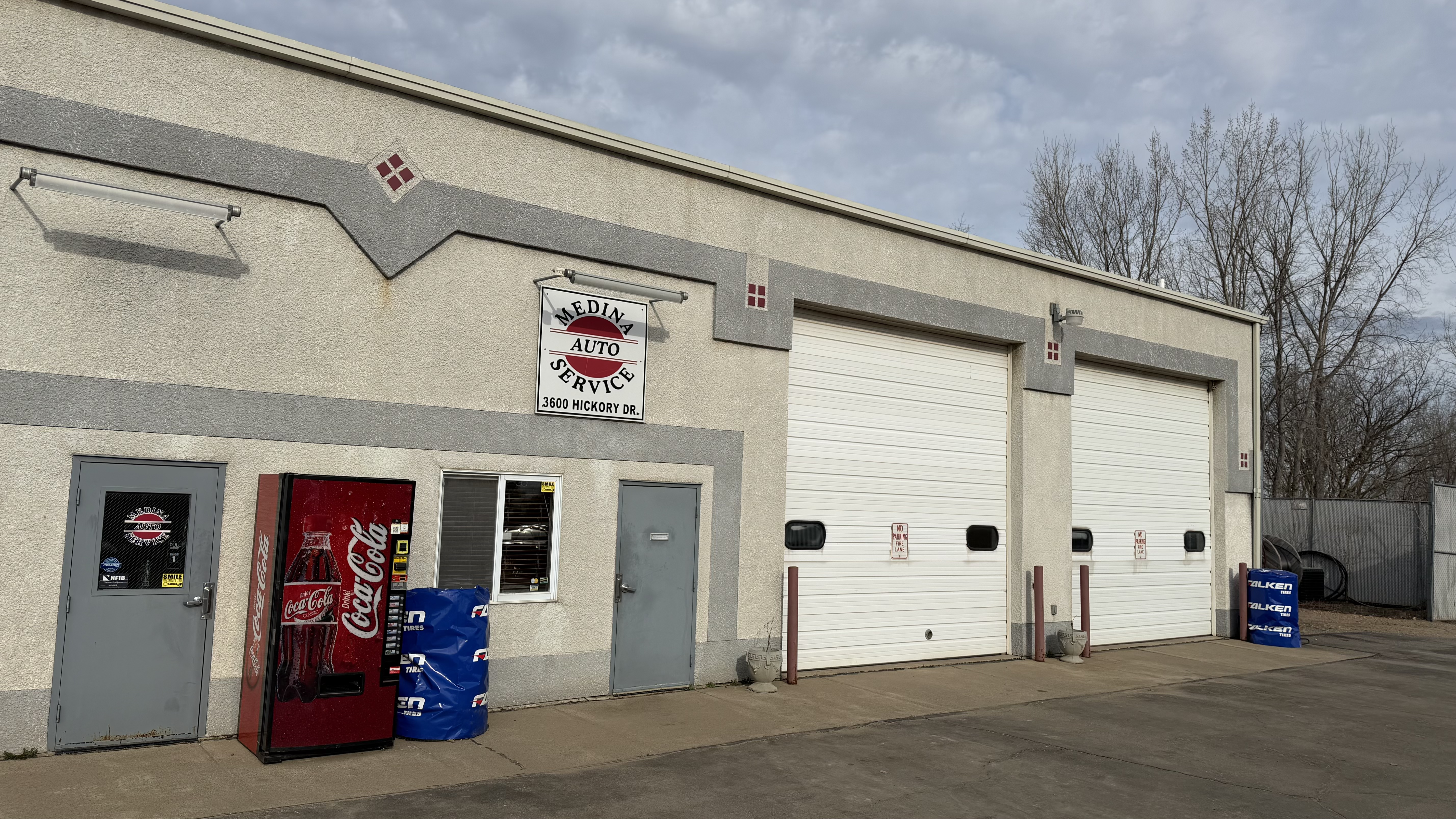Medina Auto Service exterior building with signs and garage doors